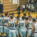 Basketball Team Standing on Courtside
