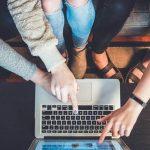 Three Person Pointing the Silver Laptop Computer